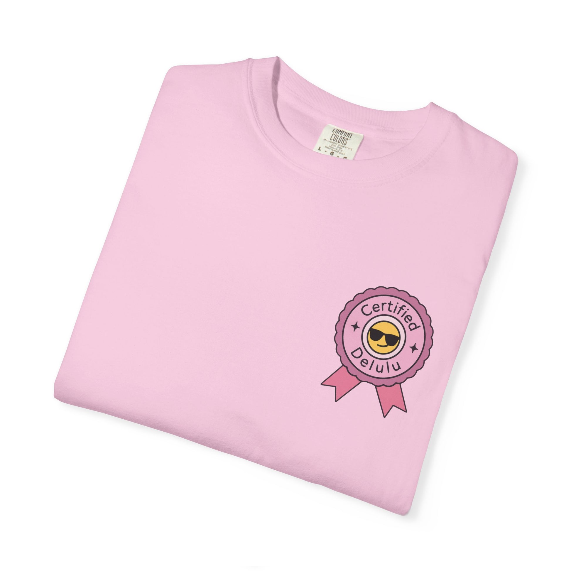 Flat lay view of the Certified Delulu Badge Comfort Tee with accessories, perfect for showcasing your quirky style and uplifting mood.