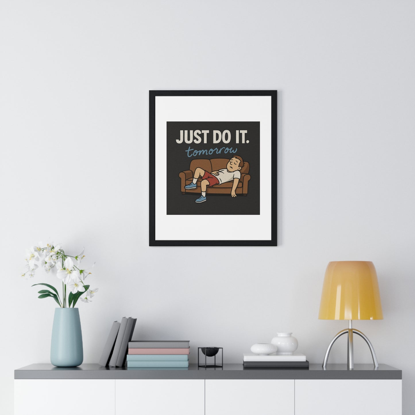 Framed motivational poster 'Just Do It... Tomorrow' that humorously celebrates the art of delay in a stylish way.