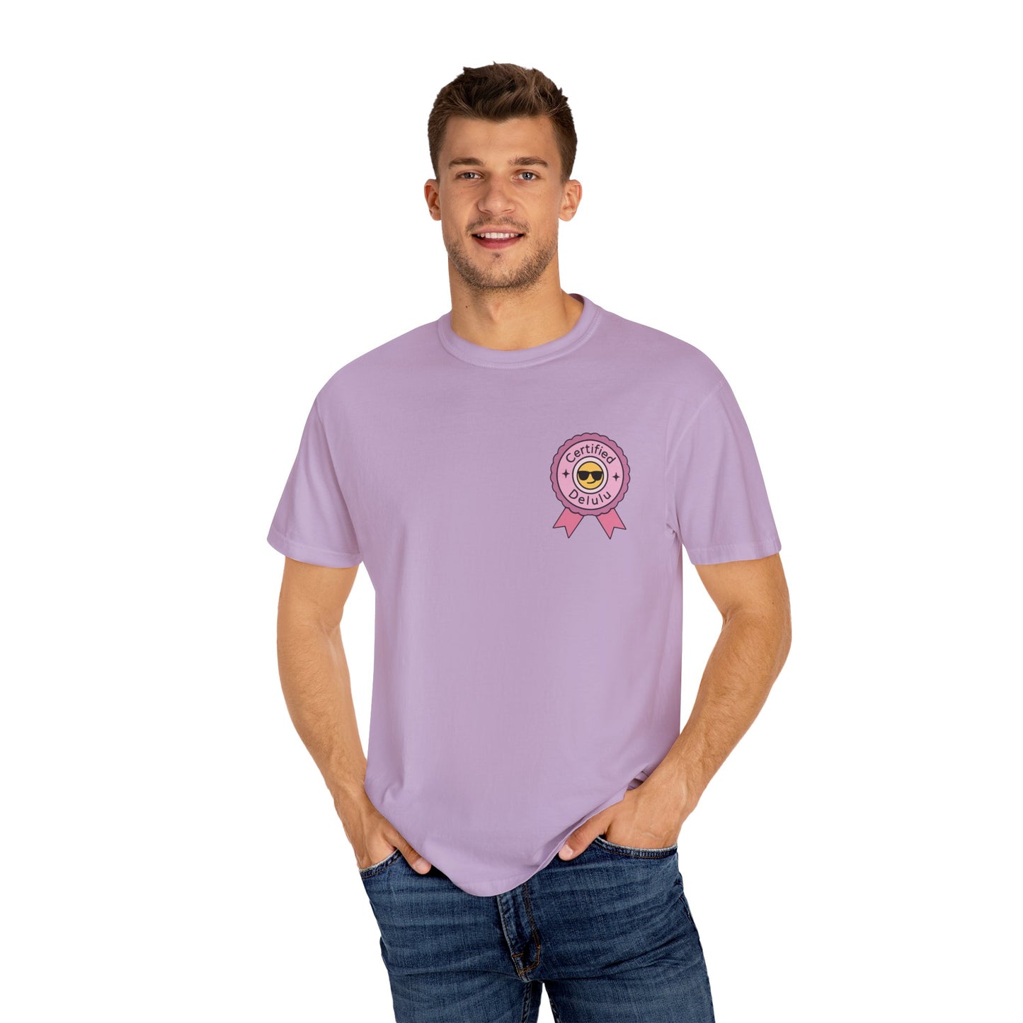 The Certified Delulu Badge Comfort Tee next to artistic elements, symbolizing the beauty of quirky and vibrant lifestyle choices.
