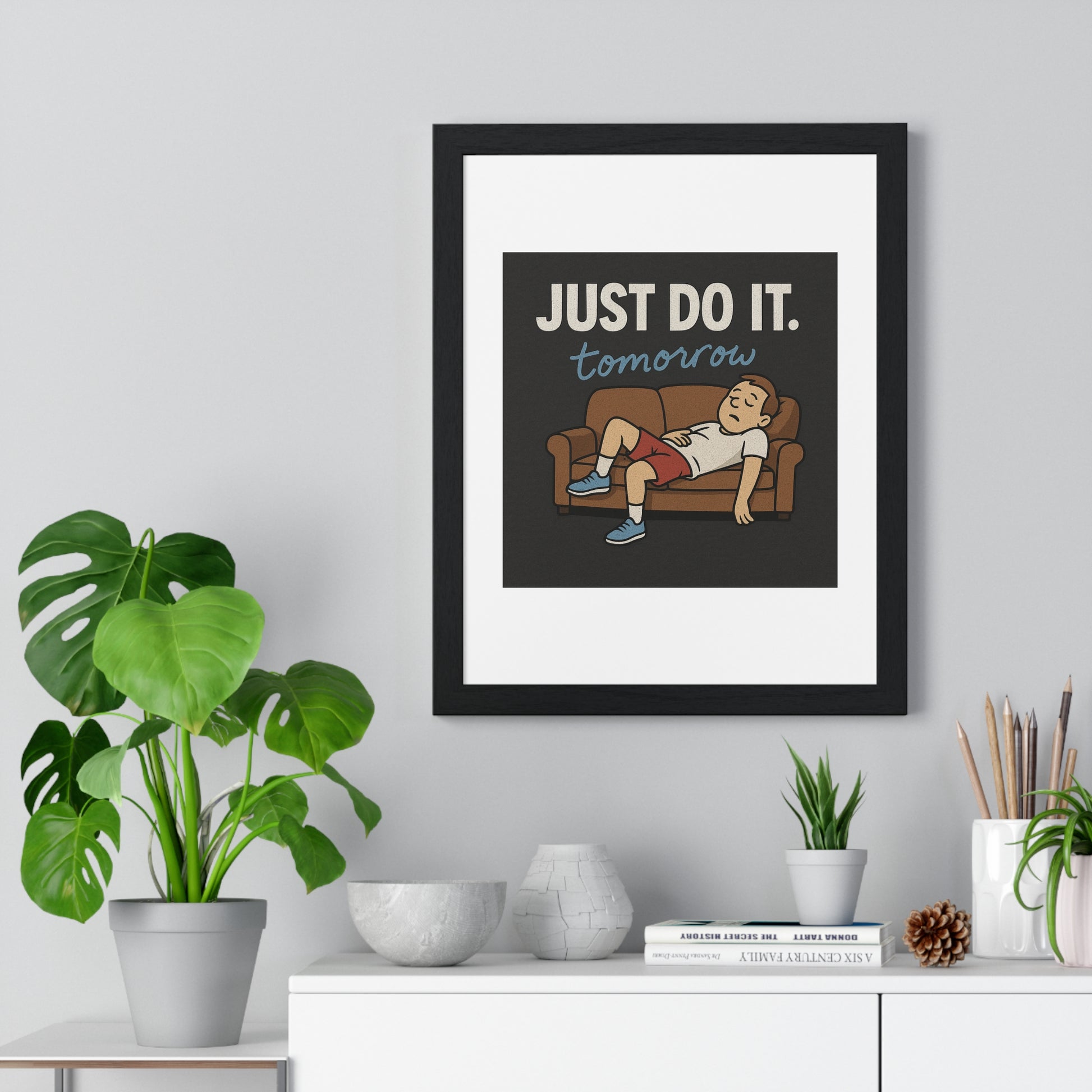 A cozy framed motivational poster titled 'Just Do It... Tomorrow' perfect for decorating your chill zone with humor.