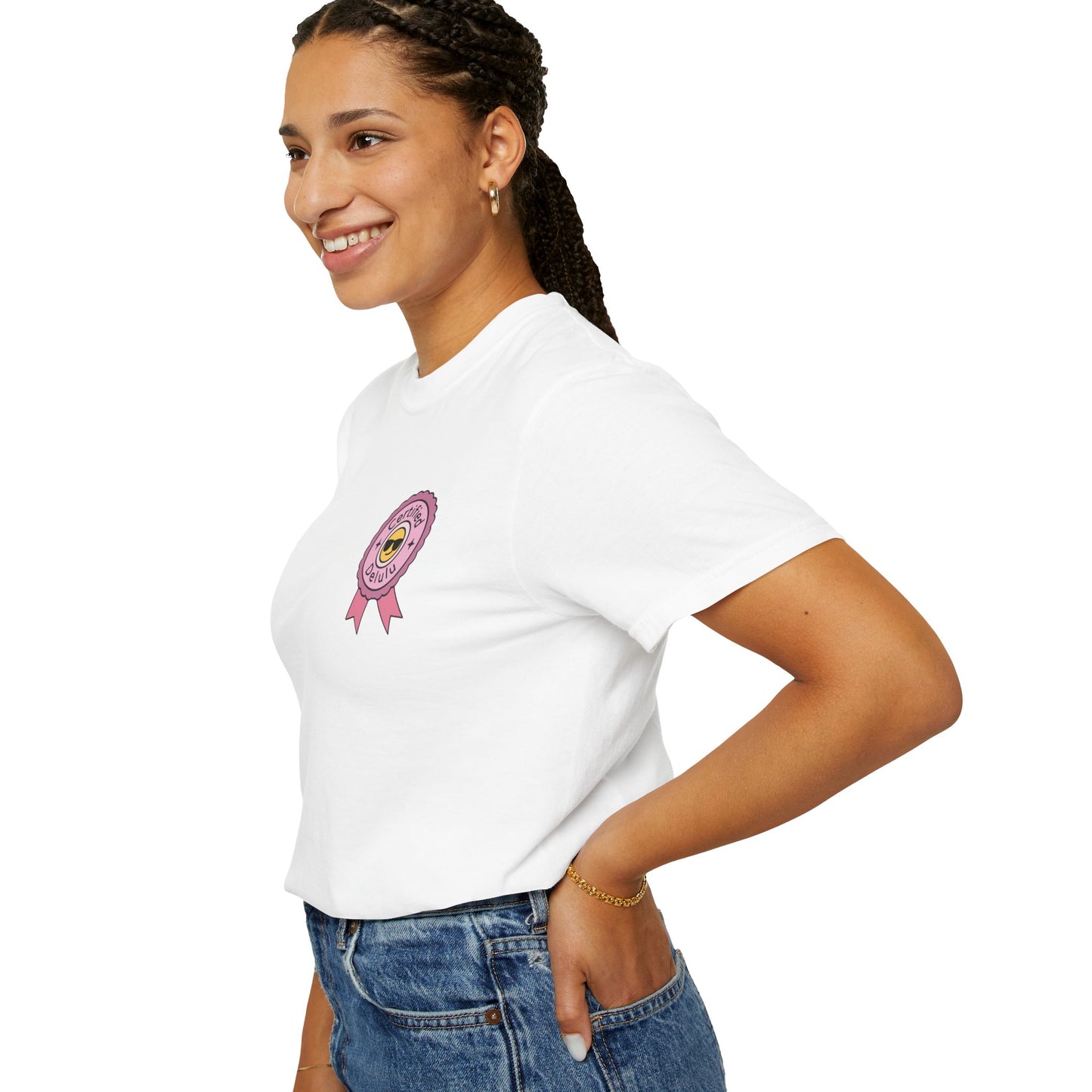 Certified Delulu Badge Comfort Tee lined up with playful props, capturing the carefree spirit and chaotic energy stitched into every thread.