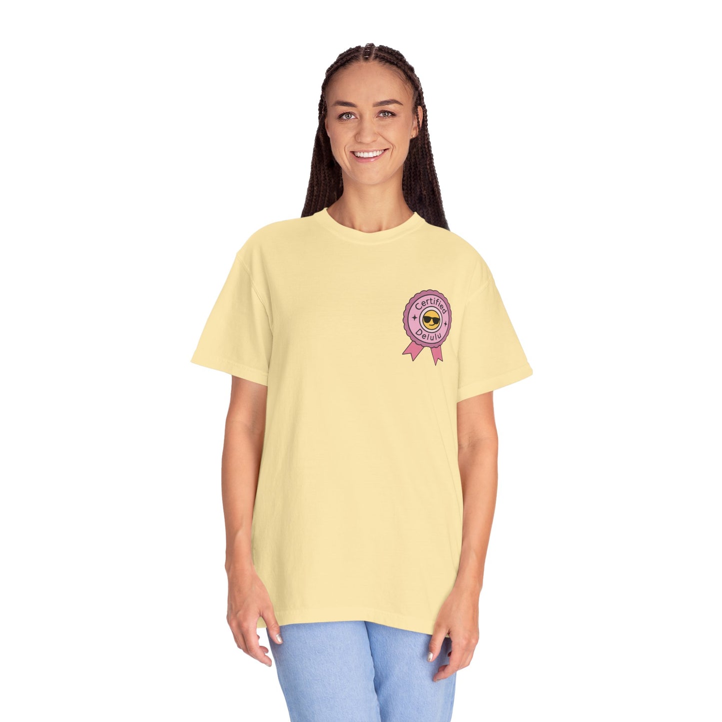 Lifestyle shot of the Certified Delulu Badge Comfort Tee outdoors, embodying a breezy day while embracing dreams and casual comfort.