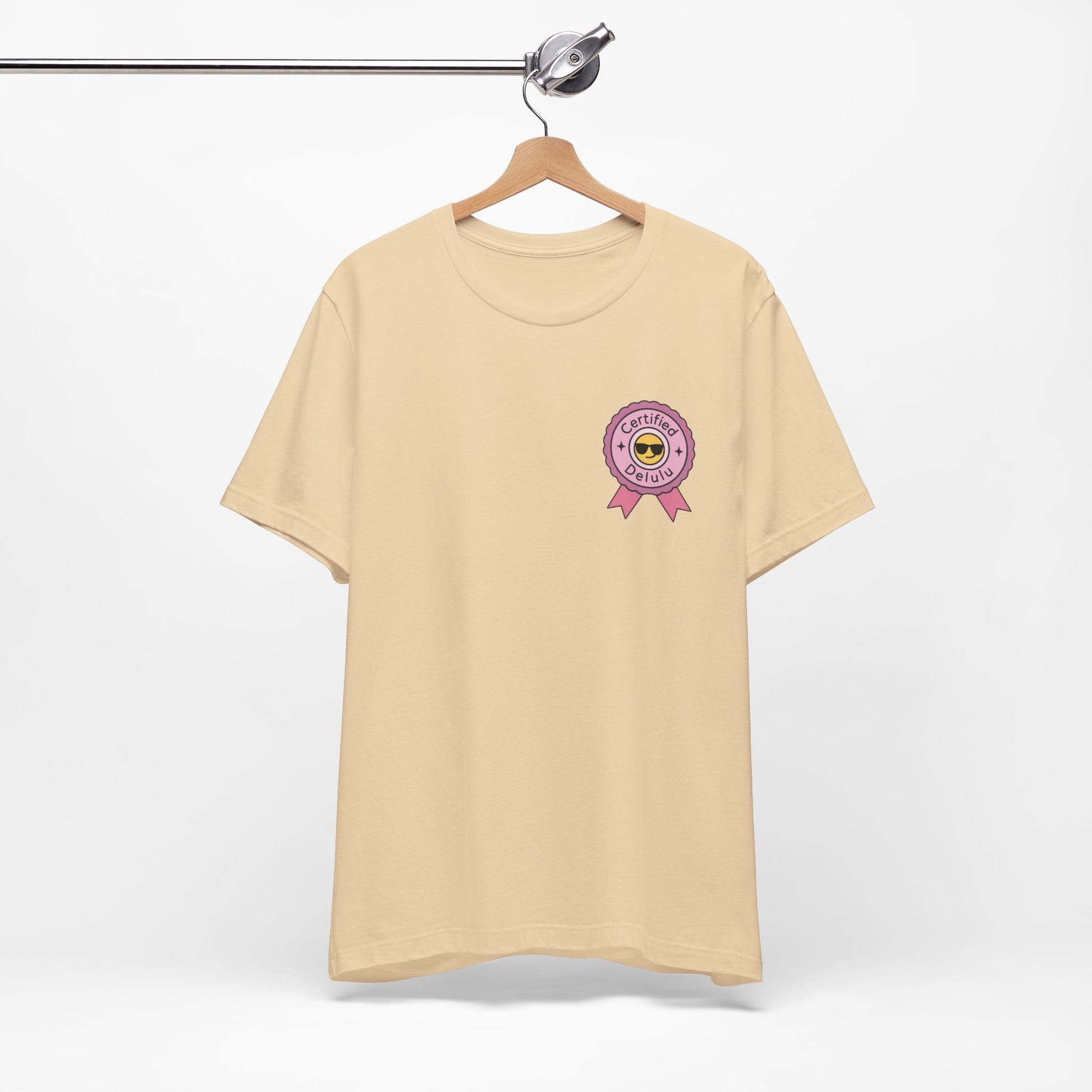 Certified Delulu Badge Unisex Tee showcasing your main character mindset; the signature delulu badge shirt for every whimsical outfit.